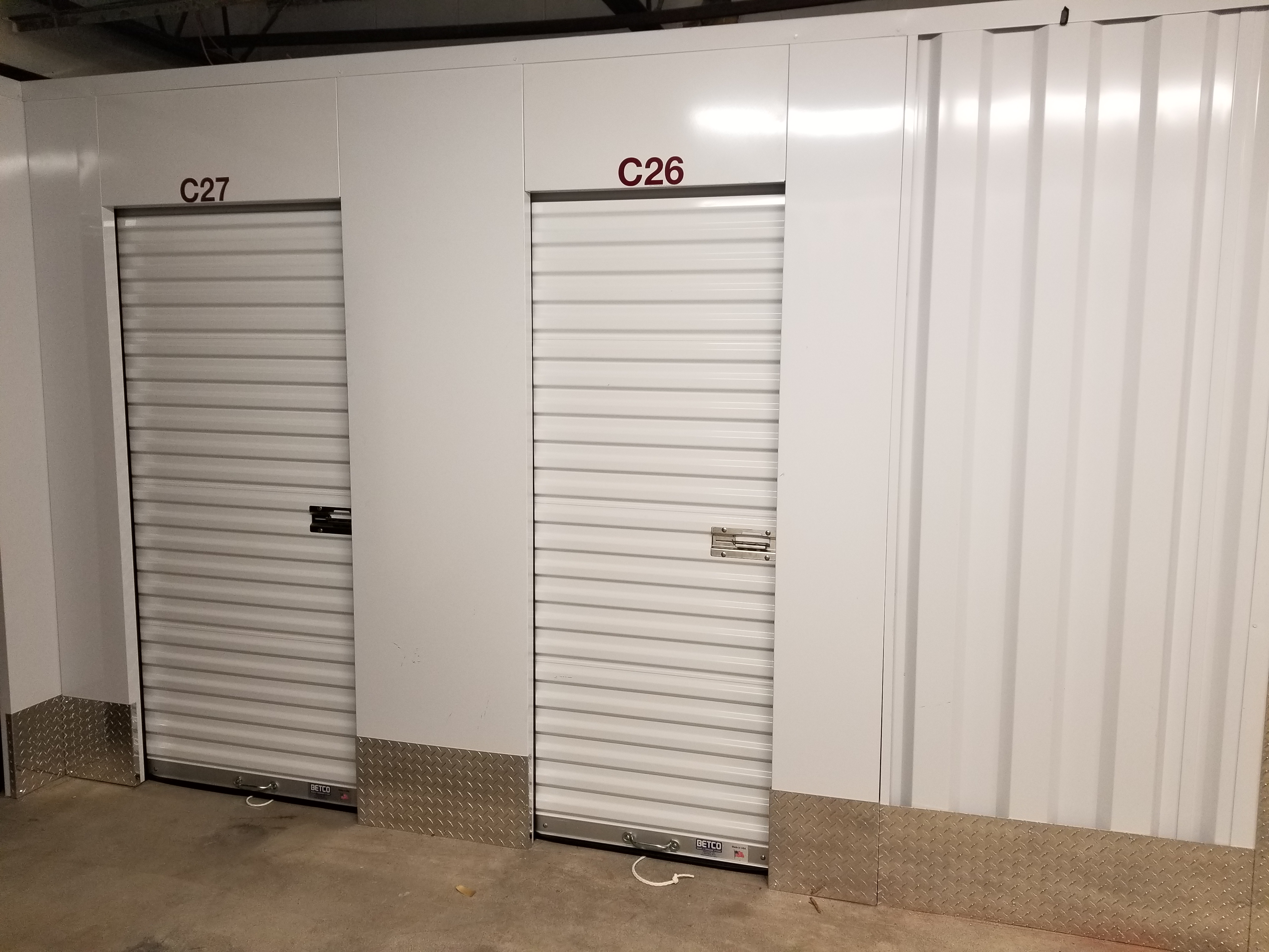Indoor storage hallway with green doors at Fort Knox 24/7 Self Storage - East Ridge, TN